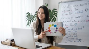 medium-shot-smiley-teacher-with-laptop